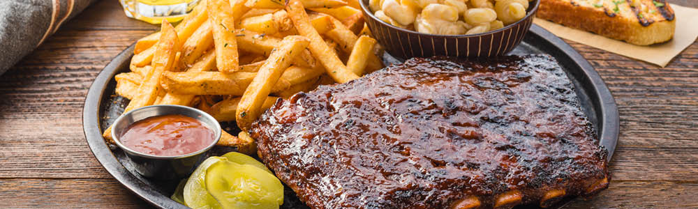 Grilled BBQ pork ribs plate with sides