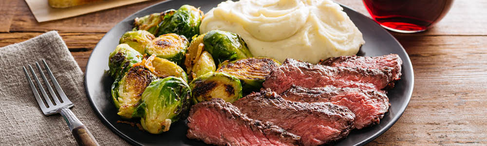 Grilled grass fed steak plate with sides